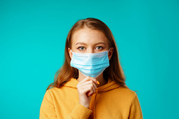 Young beautiful casual woman wearing protective medical mask - Photo, Image