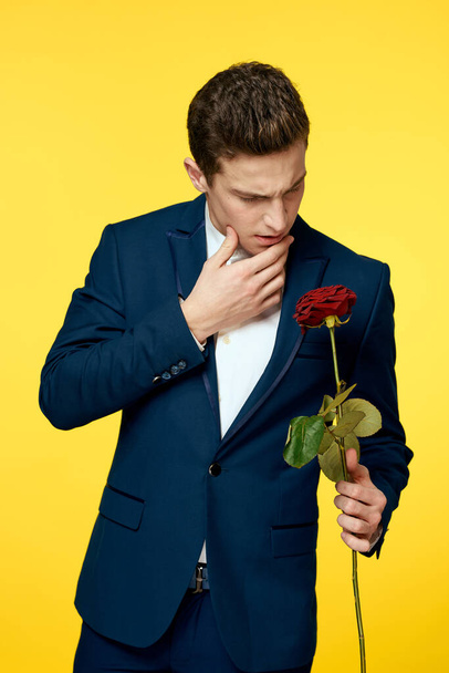 Gentlemen in classic suit on yellow background and red rose romance cropped view model portrait. - Fotoğraf, Görsel