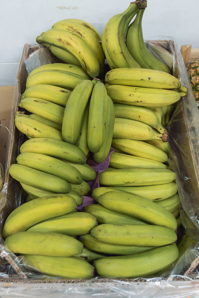 Купка бананів поміщається всередину коробки. концепція фруктів
 - Фото, зображення