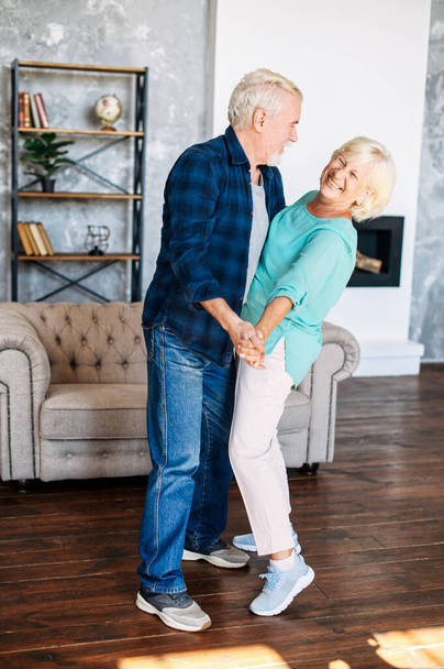 Romantic modern senior couple hagging indoors - Фото, зображення