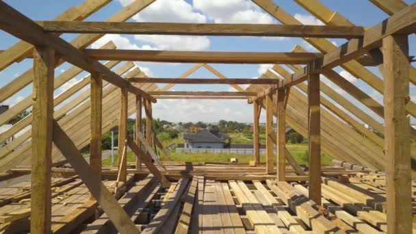 Letecký pohled na nedokončený dům s dřevěnou konstrukcí střešního rámu ve výstavbě. - Záběry, video