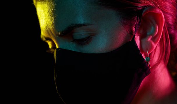 young woman wearing reusable protective mask - 写真・画像