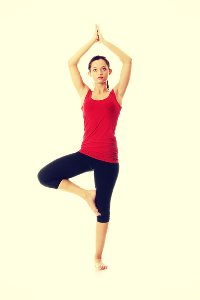 Young woman doing yoga exercise - Zdjęcie, obraz