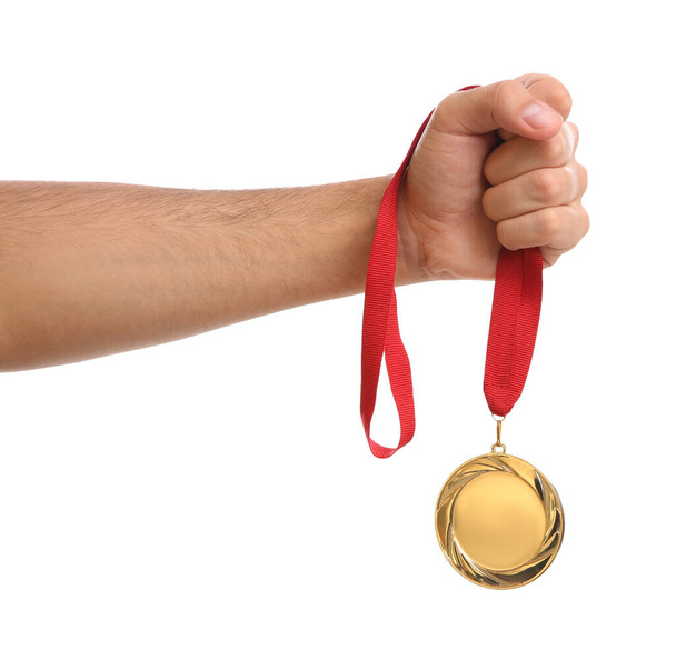 Man holding golden medal on white background, closeup. Space for design - Foto, immagini