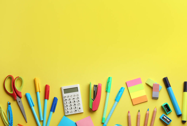 School stationery on yellow background, flat lay with space for text. Back to school - 写真・画像