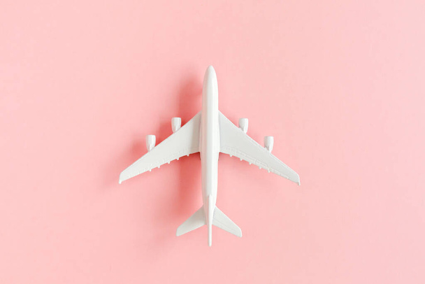 White model plane, airplane on pink background. Top view, flat lay. Banner. - Fotó, kép