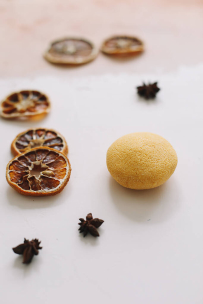 Natural soap with dried slices of oranges on a white background. Handmade soap and ingredients. Flat lay. Space for text, top view - Photo, image