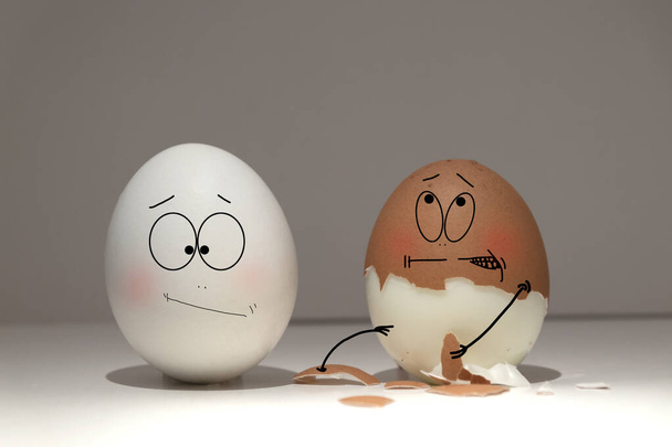 White and brown testicles show emotions towards each other - Photo, Image