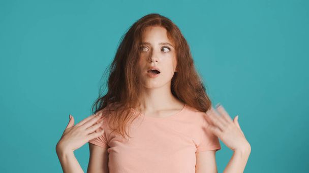 Ritratto di attraente rossa ragazza che agita le mani vicino al viso sensazione di caldo su sfondo colorato - Foto, immagini
