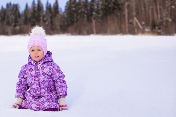 Little adorable girl enjoying snow winter sunny day - Фото, изображение