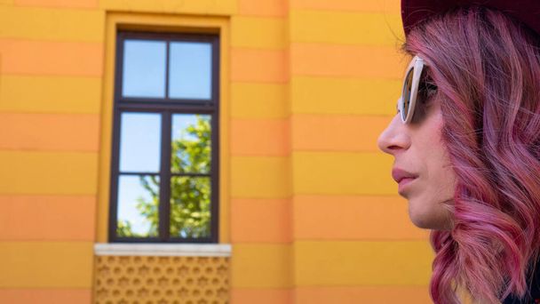Close up of a young woman in front of high school building in Mostar.  - Photo, Image