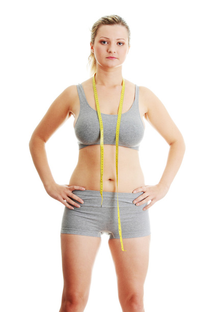 Woman measuring her waist - Foto, Imagen