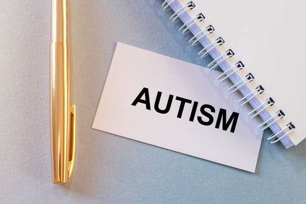 Autism. Word on paper on blue table. - Fotoğraf, Görsel