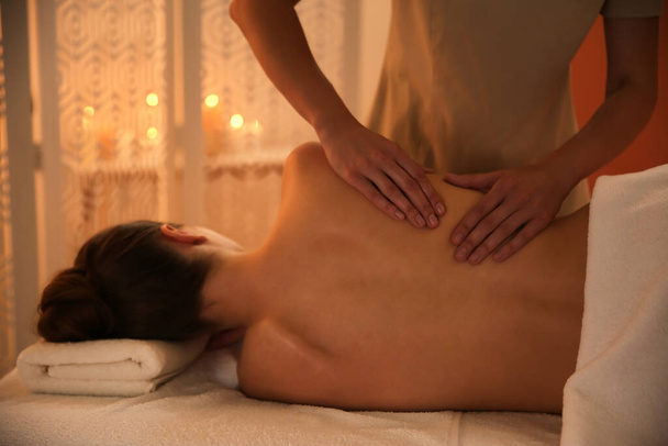 Young woman receiving back massage in spa salon - Foto, Imagem