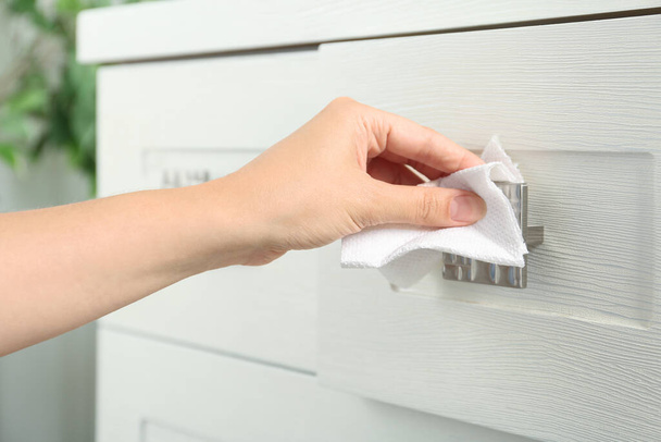Woman using tissue paper to open drawer, closeup - Zdjęcie, obraz
