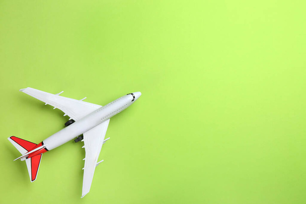 Toy airplane on green background, top view. Space for text - Foto, Imagem