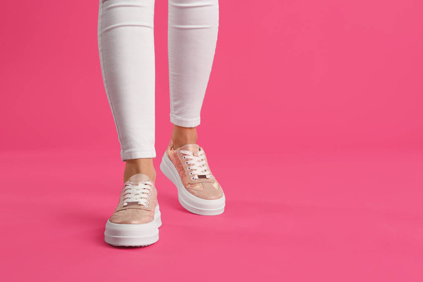 Woman wearing shoes on pink background, closeup. Space for text - Φωτογραφία, εικόνα