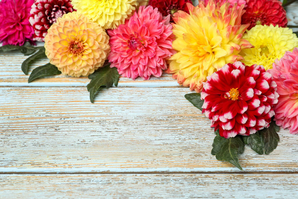 Beautiful dahlia flowers on wooden background. Space for text - Φωτογραφία, εικόνα