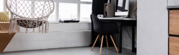 Panoramiczna orientacja wnętrza studia z wiszącym krzesłem i miejscem pracy - Zdjęcie, obraz