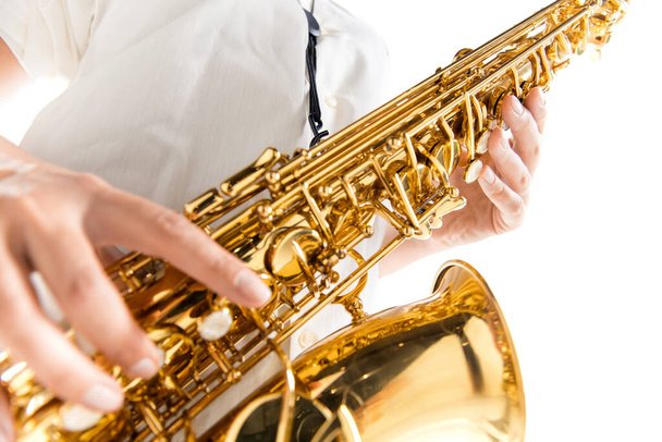 Close up woman playing saxophone isolated on white studio background - Foto, Bild