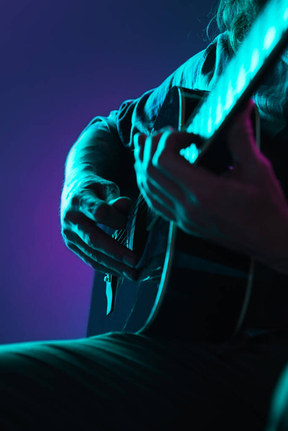 Close up of guitarist hand playing guitar, copyspace, macro shot - Fotografie, Obrázek