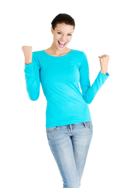 Excited happy young woman with fists up - 写真・画像