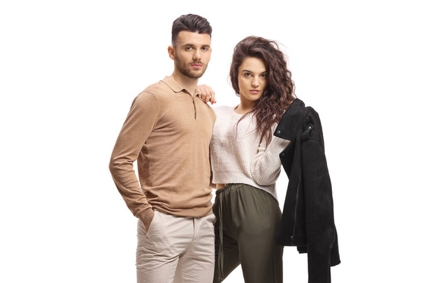Fashionable young couple standing and posing isolated on white background - Foto, afbeelding