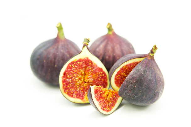 Ripe sweet fresh figs fruit isolated on white background. Whole fruit and sliced - Photo, Image