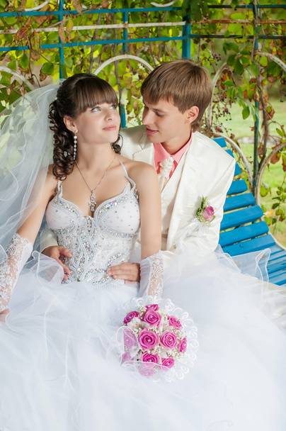 νεαρή και όμορφη νύφη και ο γαμπρός στον πάγκο - Φωτογραφία, εικόνα