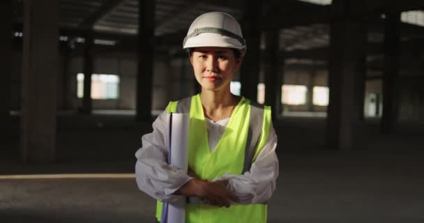 Portrait Asian Industrial Engineer Woman In Hard Hat Wearing Safety Jacket Working In The Building Construction Site, Dolly Shot - Footage, Video
