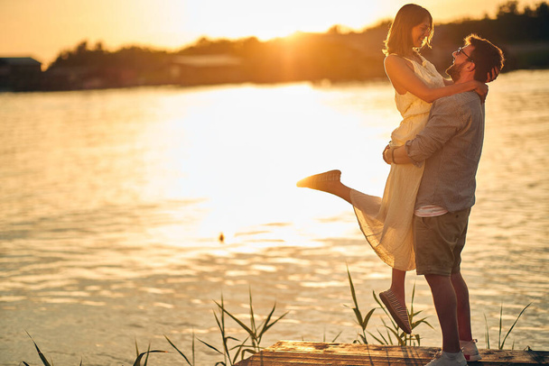 Young couple and lovely moments on the sunset on the lake - Foto, Imagem