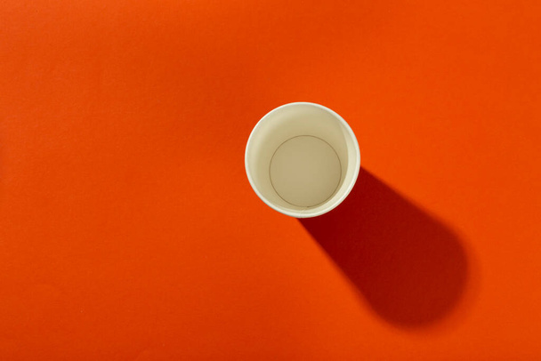 Paper cup for coffee on an orange background. Coffee to go. Top view. - Φωτογραφία, εικόνα