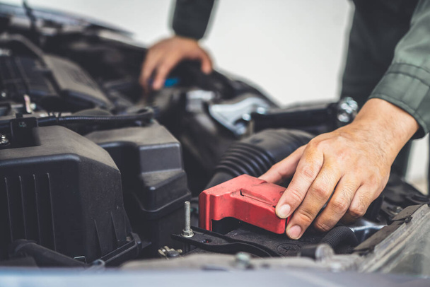 Professional mechanic hand providing car repair and maintenance service - Foto, imagen