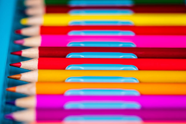 Colorful pencils with blurred background in blue box. Close up - Foto, Bild