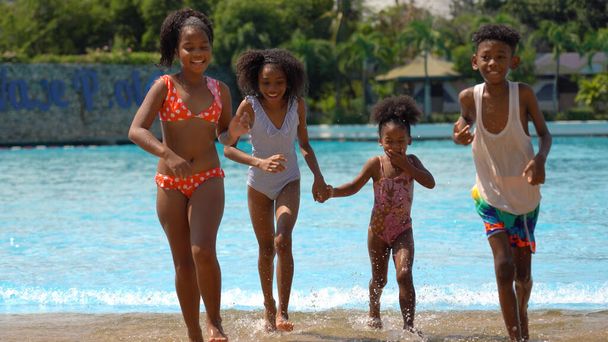 African kid having fun on vacation at a water park - Photo, Image