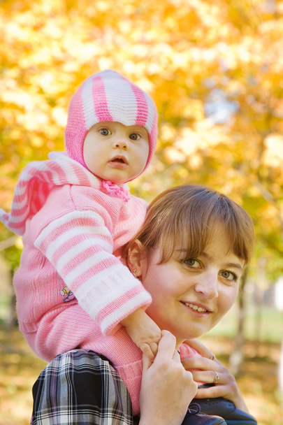 Mother with baby outdoor in autumn - Φωτογραφία, εικόνα