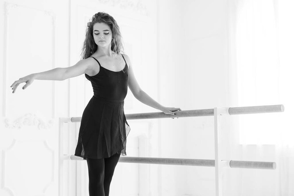 Girl ballerina with curly hair. Black and white photo. BW - Фото, изображение