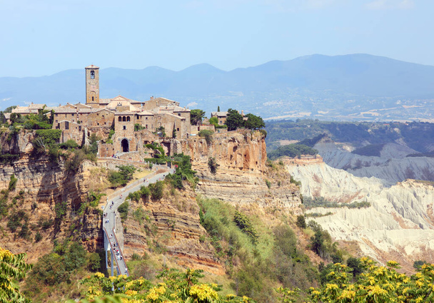 incredible view of a village perched on the hill that can only be reached by a narrow pedestrian bridge called Civita di Bagnoregio - Photo, Image