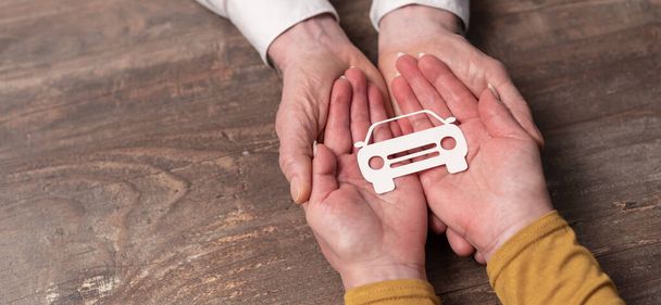Concept d'assurance auto avec voiture en papier dans les mains - Photo, image