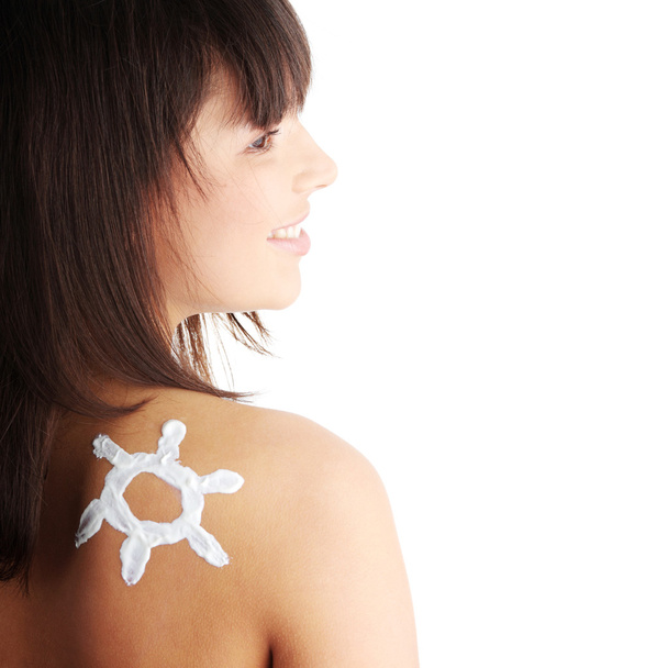 Young woman with sun-shaped sun cream - Φωτογραφία, εικόνα