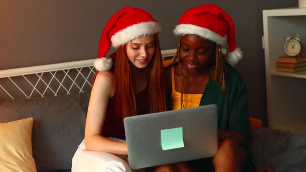 mixed race couple in santa claus hat at home in evening - Footage, Video