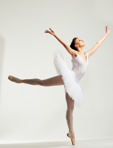 Young ballerina dancer in tutu showing her techniques  - 写真・画像