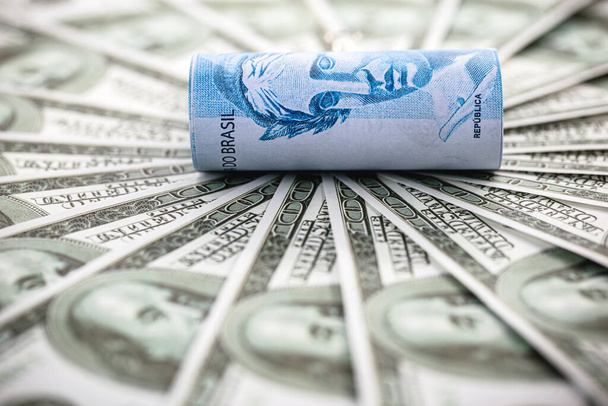 yksityiskohdat sadasta Reais Bill ympäröi 100 dollarin seteleitä, käsite rahoituskriisin välillä Brasilian ja Yhdysvaltojen - Valokuva, kuva