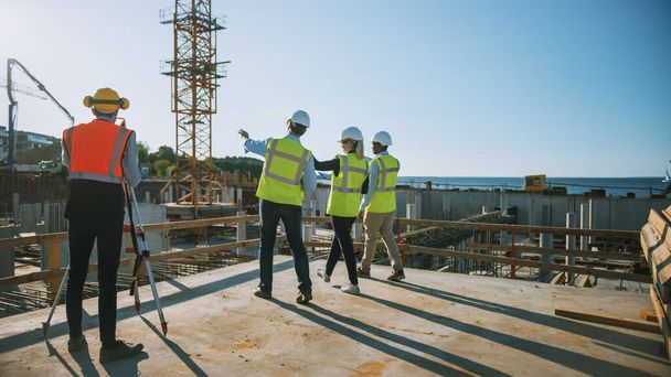 Diverse Team of Specialists are Walking on Construction Site. Real Estate Building Project with Civil Engineer, Architect, Business Finance Investor Discussing Planning and Development Details. - Foto, immagini