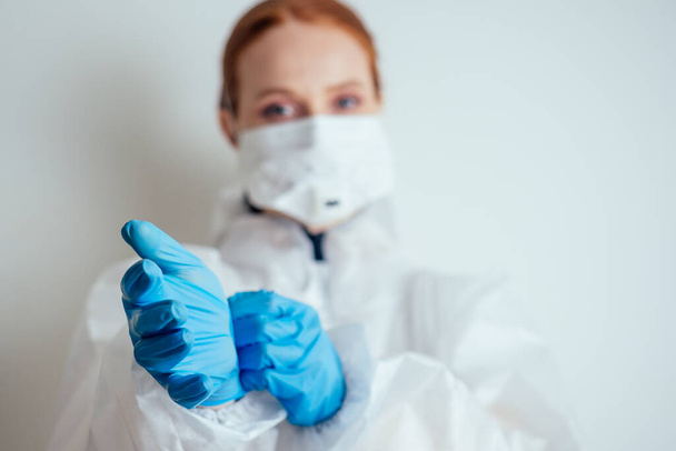 virologist woman in chemical protection mask ,glasses and gloves holding potential vaccine at the lab - Foto, immagini