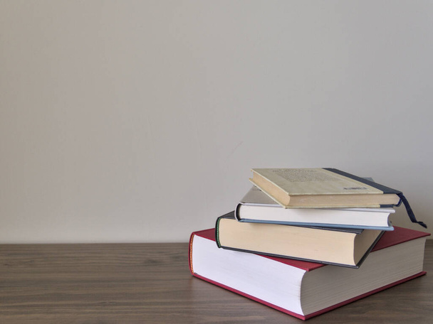 Stack of books on a table with light colored background.Education learning and reading concept - Photo, Image
