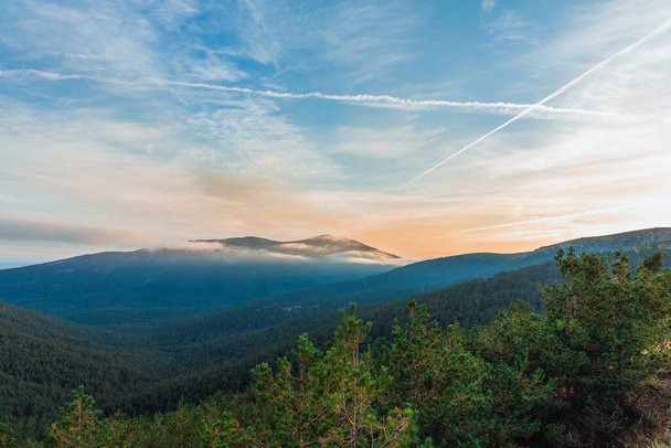 красивий схід сонця в горах з зеленими деревами і блакитним небом з хмарами
 - Фото, зображення