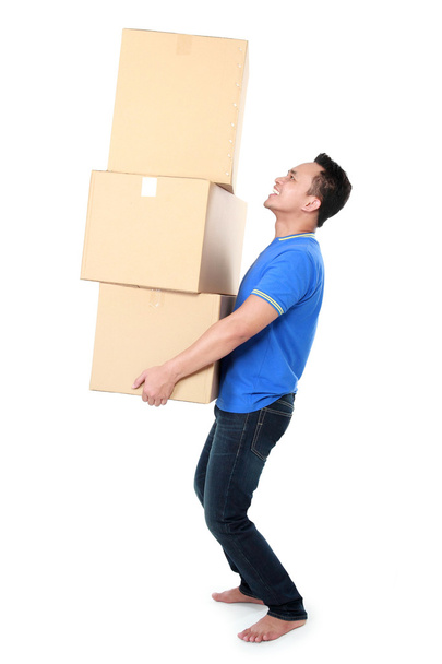 Smiling young man holding cardboard box - Photo, Image