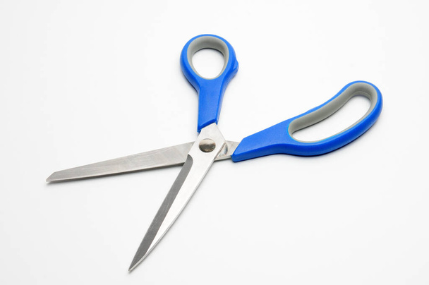 Scissors with a blue handle for tailors on an isolated white background - Foto, Bild