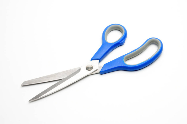 Scissors with a blue handle for tailors on an isolated white background - Foto, Imagen